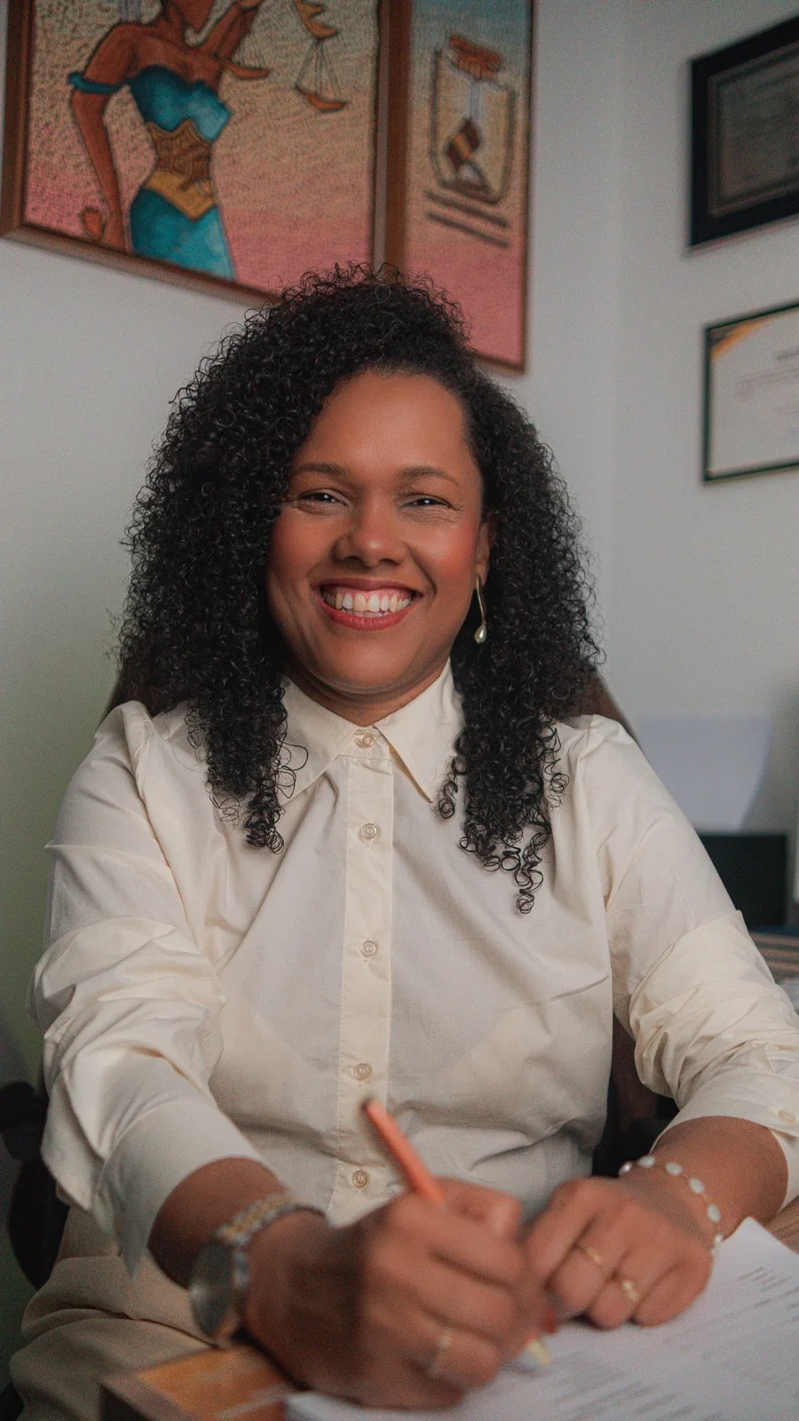 Dra Luanda Naiara sorrindo assinando documento